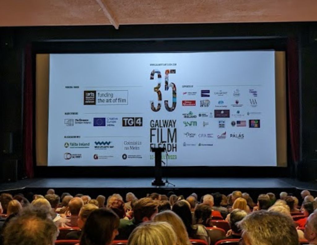Galway Film Fleadh Screening Event in a Cinema – A packed cinema audience watches a presentation for the 35th Galway Film Fleadh, with a large screen displaying festival sponsors and logos, indicating an official screening or awards event.